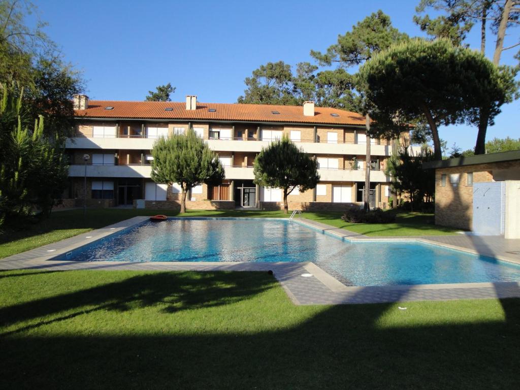 a swimming pool in front of a building at Casa Casais in Fão