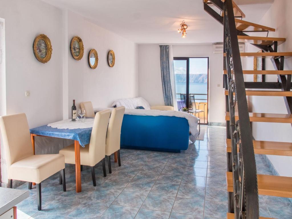 a bedroom with a bed and a table and chairs at Apartment Stana in Novi Vinodolski