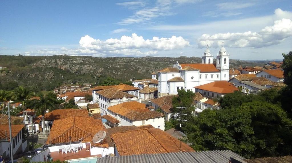 a view of a town with a church and roofs at APARTAMENTOS ALTOS DA GRUPIARA - DIAMANTINA/MG in Diamantina