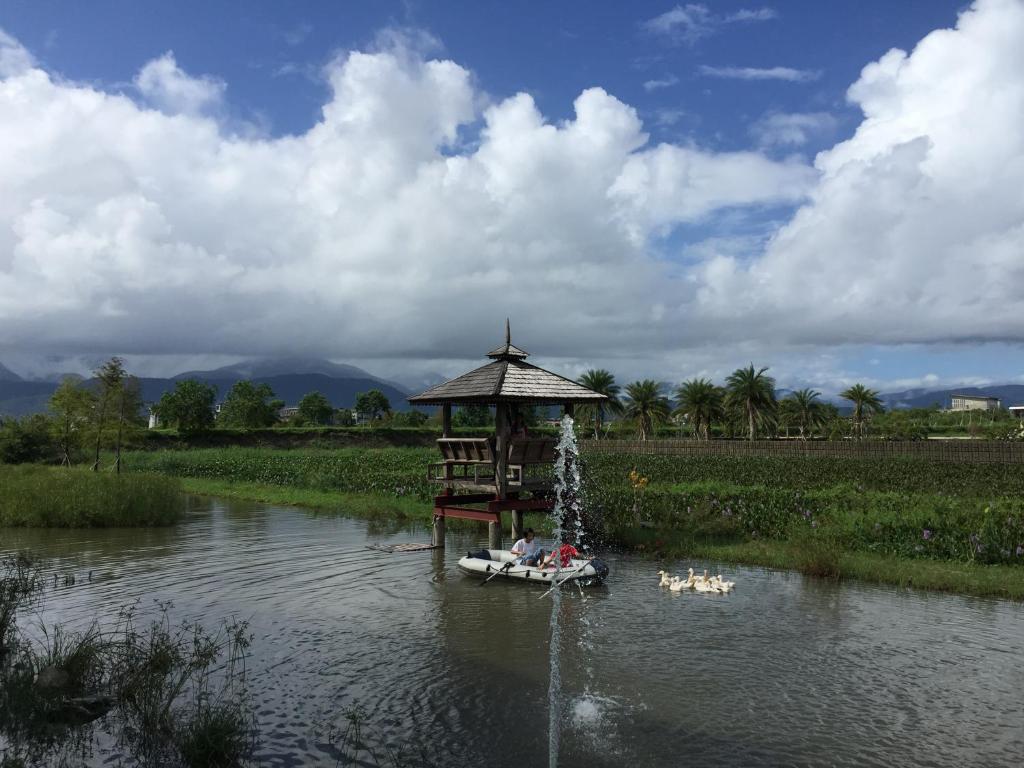 a group of people in a small boat in a river at Beautiful Yilan Resort in Dongshan