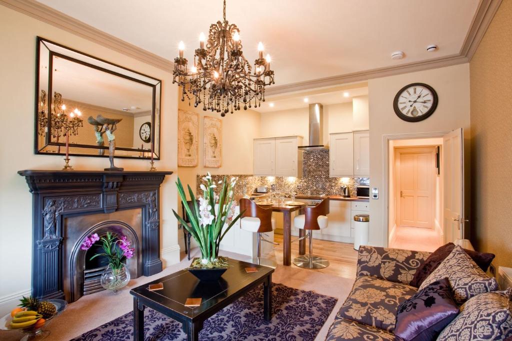 a living room with a couch and a fireplace at Portland Apartments in Cheltenham