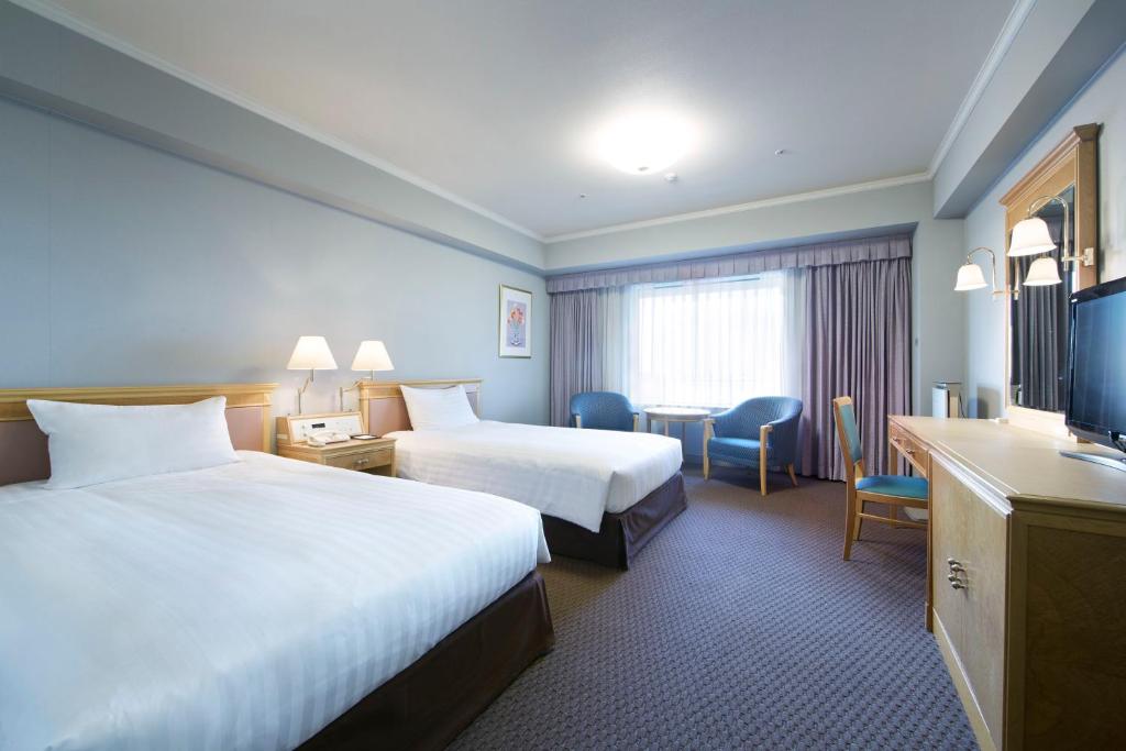 Postel nebo postele na pokoji v ubytování Hotel Agora Regency Osaka Sakai