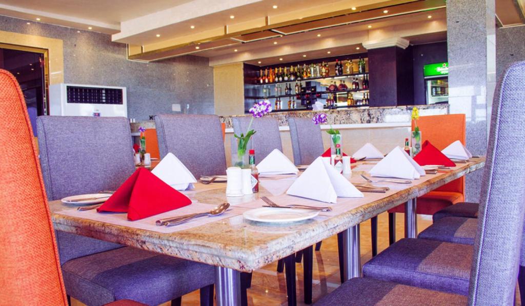 a table in a restaurant with red napkins on it at BWC Hotel in Lagos