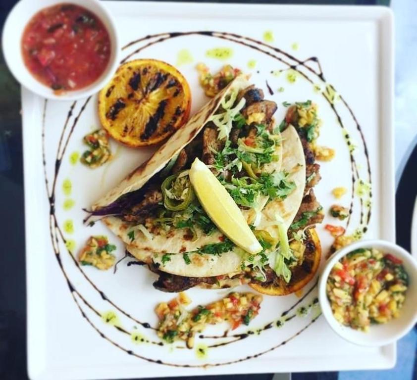 a plate of food with fish and a lemon on it at BWC Hotel in Lagos
