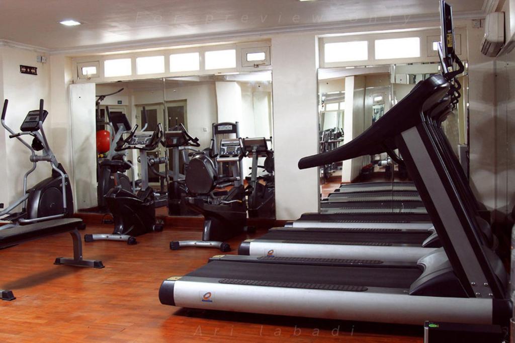 a gym with rows of treadmills and machines at BWC Hotel in Lagos
