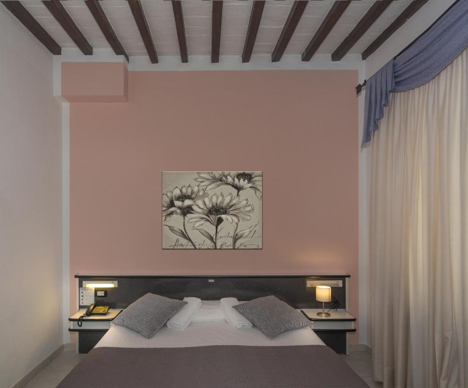 Postel nebo postele na pokoji v ubytování Hotel Amalfitana