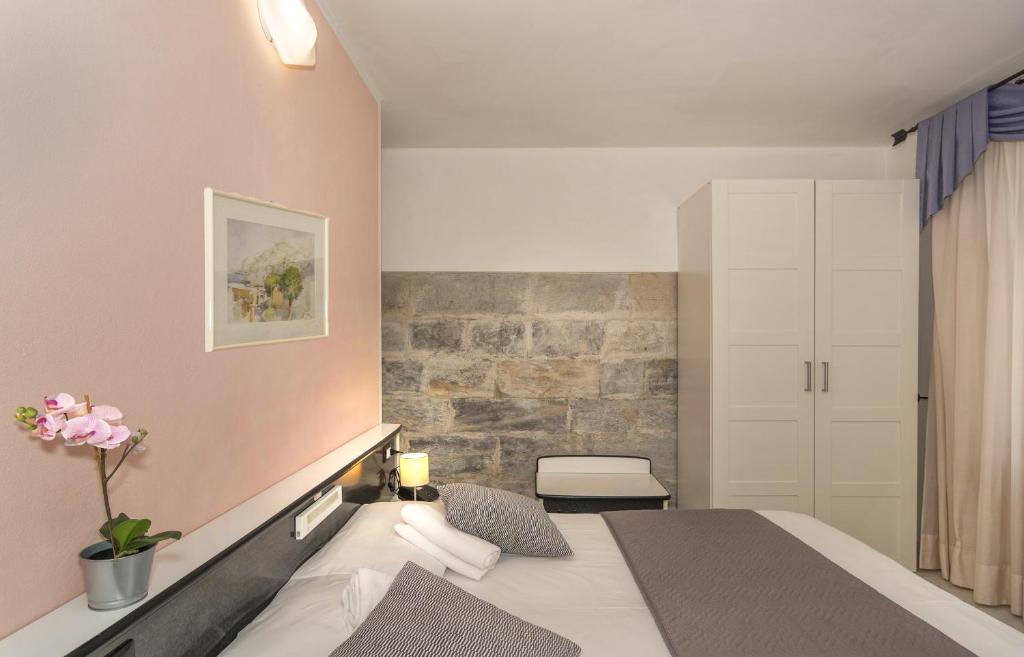 Postel nebo postele na pokoji v ubytování Hotel Amalfitana