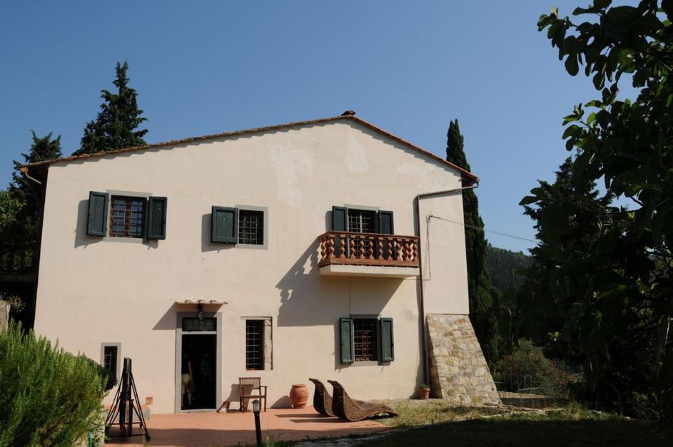 a large white house with a balcony on top of it at Villa Il Bosco in Fiesole