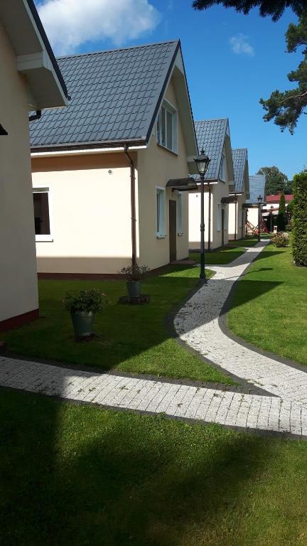 a house with a pathway in front of a house at Liwia in Niechorze