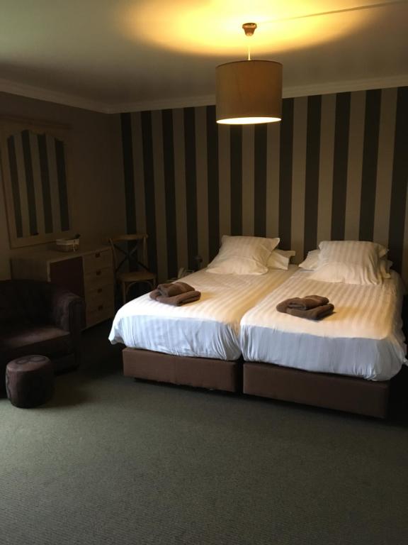 Postel nebo postele na pokoji v ubytování Hotel Oude Abdij