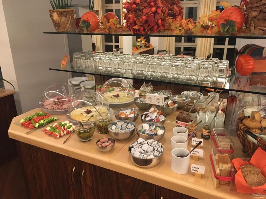 a buffet with many different types of food on a table at Stadthotel Berggeist in Penzberg