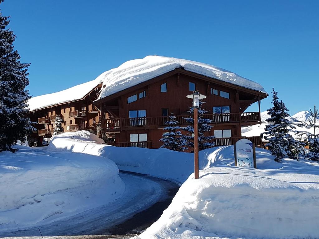 a large building covered in snow in front at Premium Les Alpages de Chantel in Arc 1800