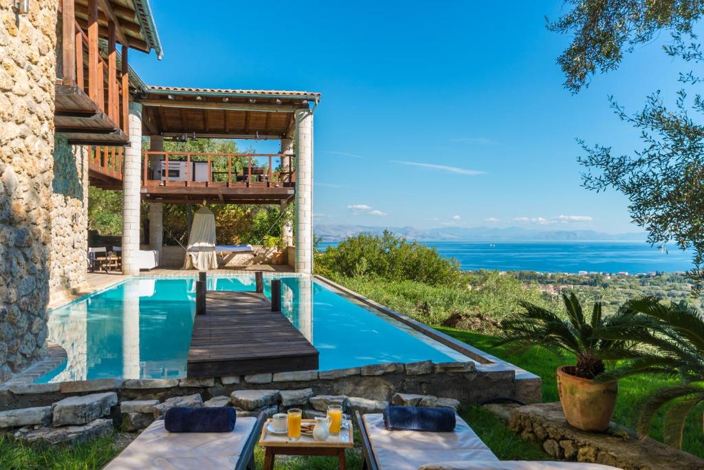 a villa with a swimming pool with a view at Villa Bournella in Ýpsos