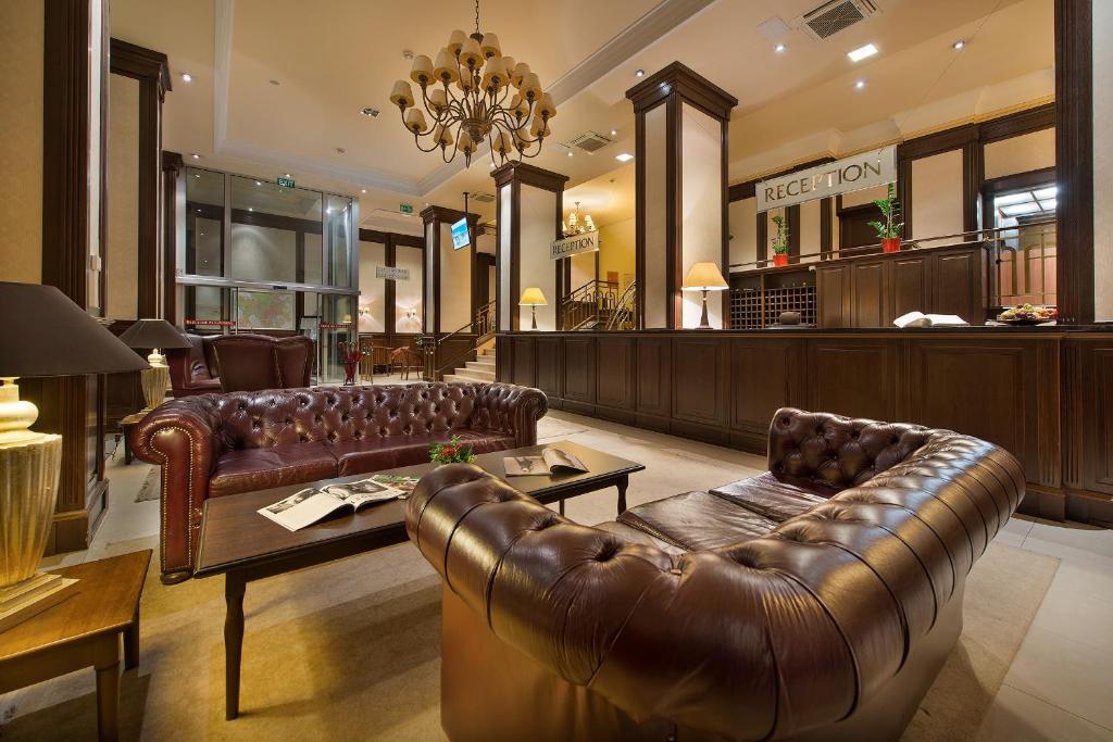 a store with a leather couch and a coffee table at Apollo Hotel Bratislava in Bratislava
