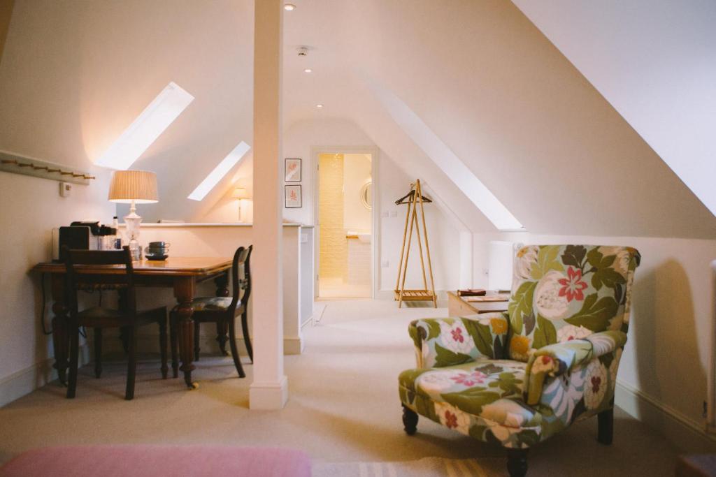 a living room with a chair and a table at The Hero in Burnham Market