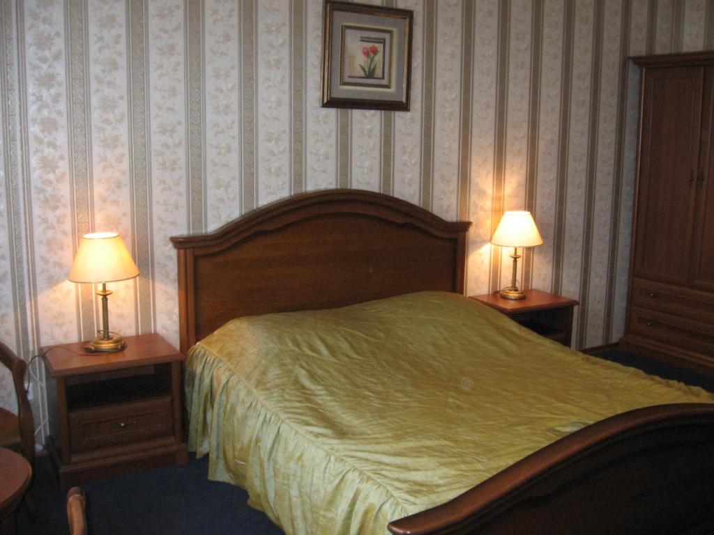 Postel nebo postele na pokoji v ubytování Diplomat ApartHotel