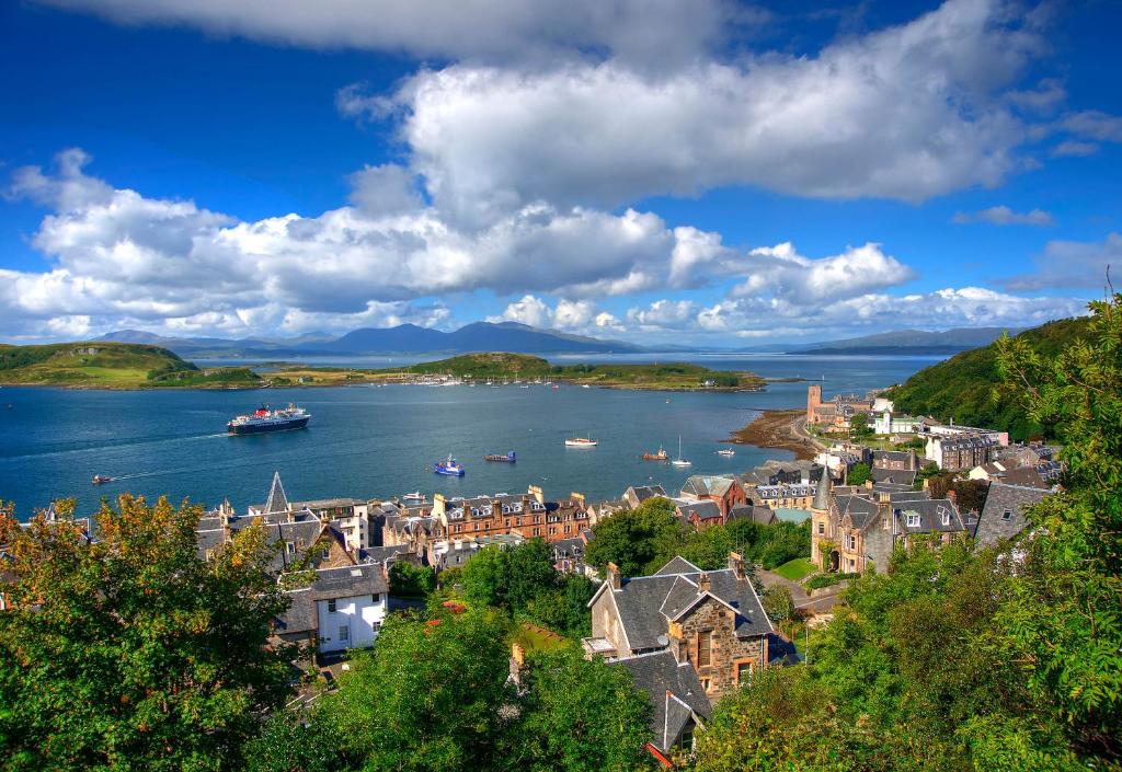 a town on a river with boats in the water at Muthu Alexandra Hotel in Oban