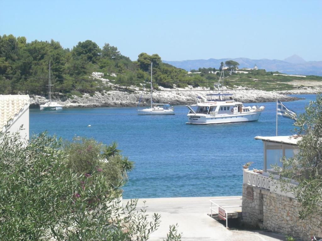 two boats are docked in a large body of water at Baronessa's Apartments in Gaios