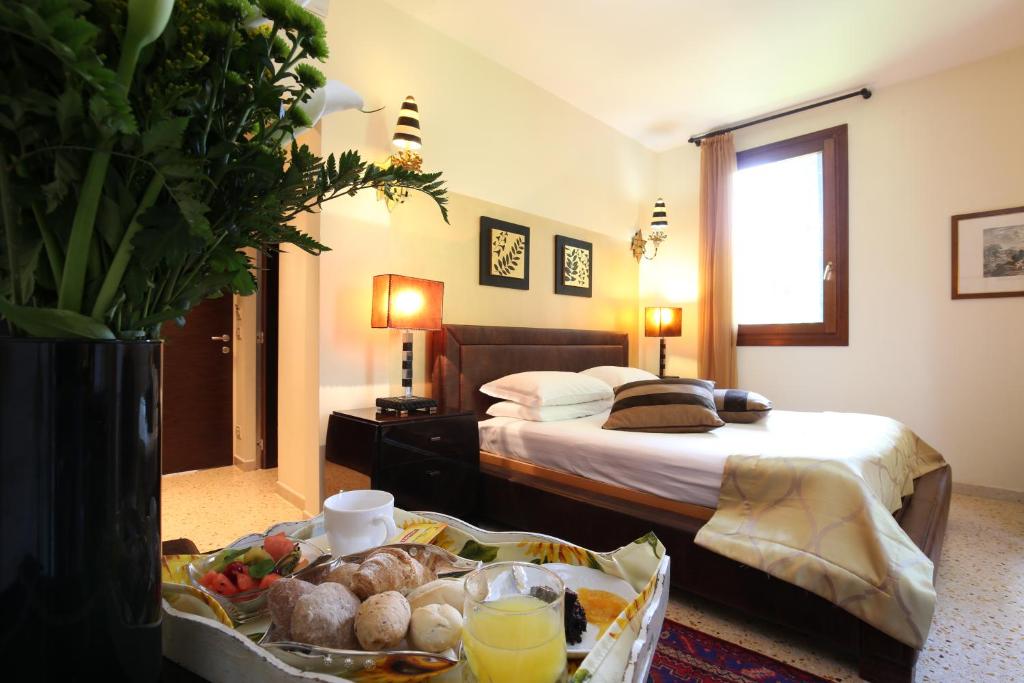 Postel nebo postele na pokoji v ubytování Hotel Villa Stella