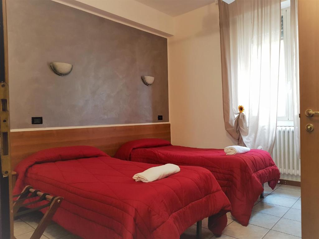 Postel nebo postele na pokoji v ubytování Hotel Marinoni