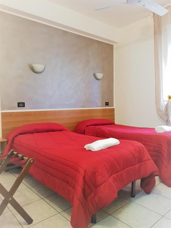 Postel nebo postele na pokoji v ubytování Hotel Marinoni
