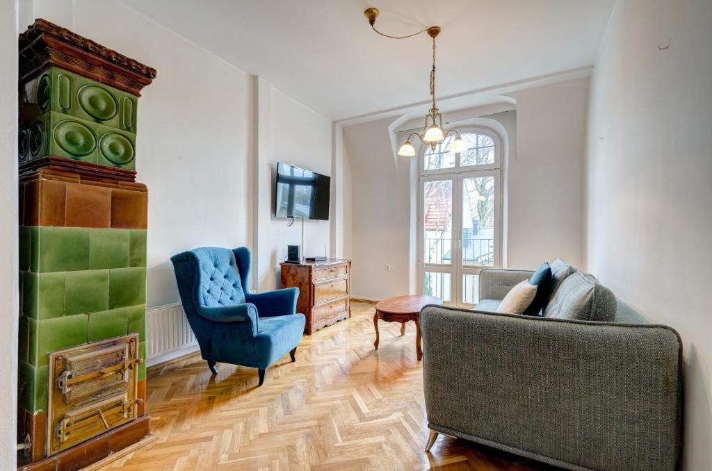 a living room with a couch and two chairs at Dom & House - Apartment Fiszera Sopot in Sopot