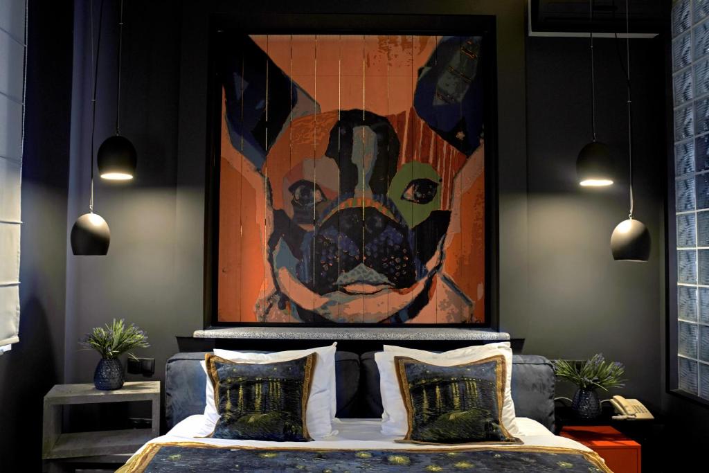 a bedroom with a bed with a painting on the wall at MaNNa Boutique Hotel in Kyiv