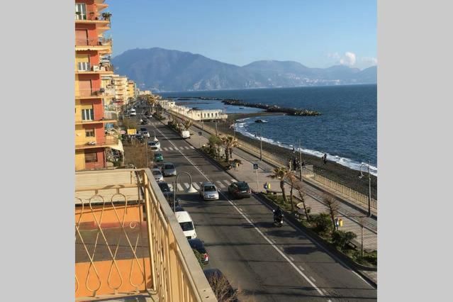 a view of a street and the ocean from a building at Appartamento Solemare in Torre del Greco