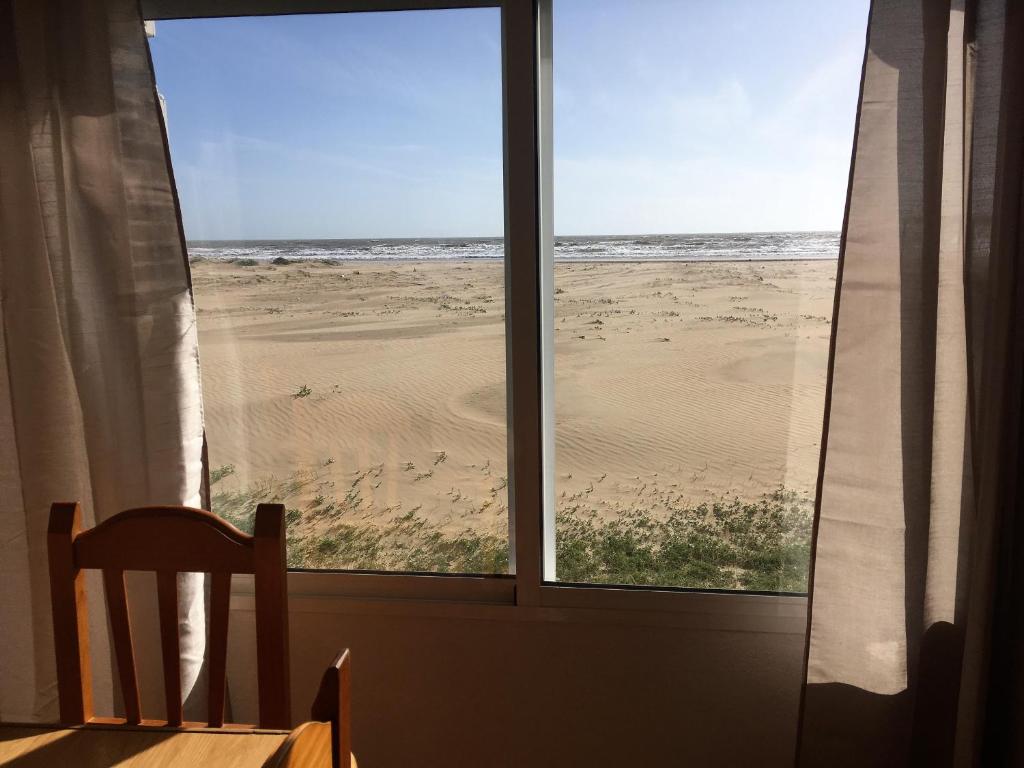 a view of the beach from a window at Apartamentos Calypso in Punta Umbría