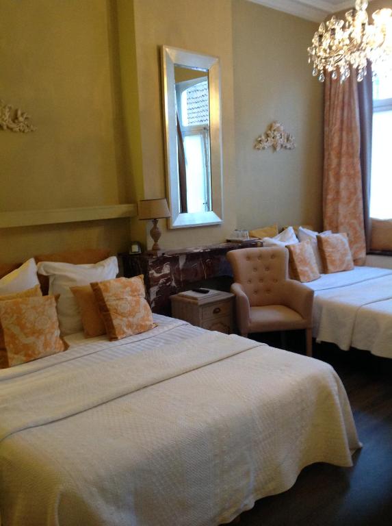 En eller flere senger på et rom på Hotel Botaniek
