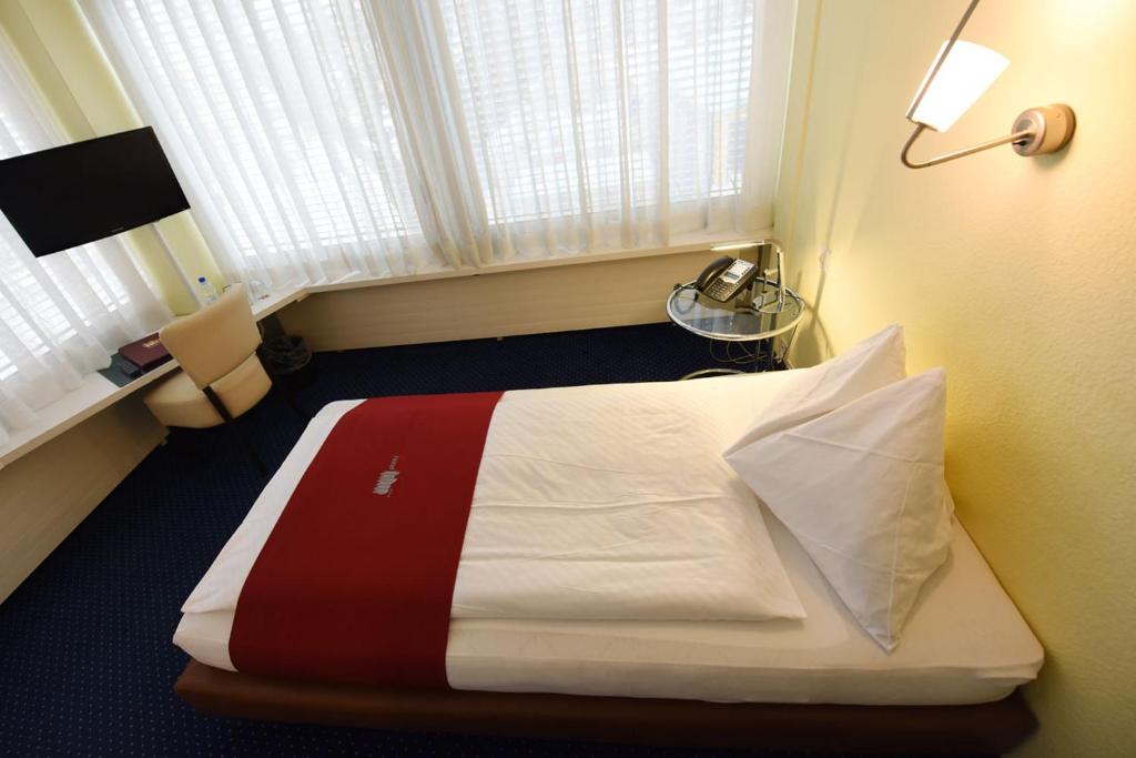Voodi või voodid majutusasutuse Hotel Dufour toas