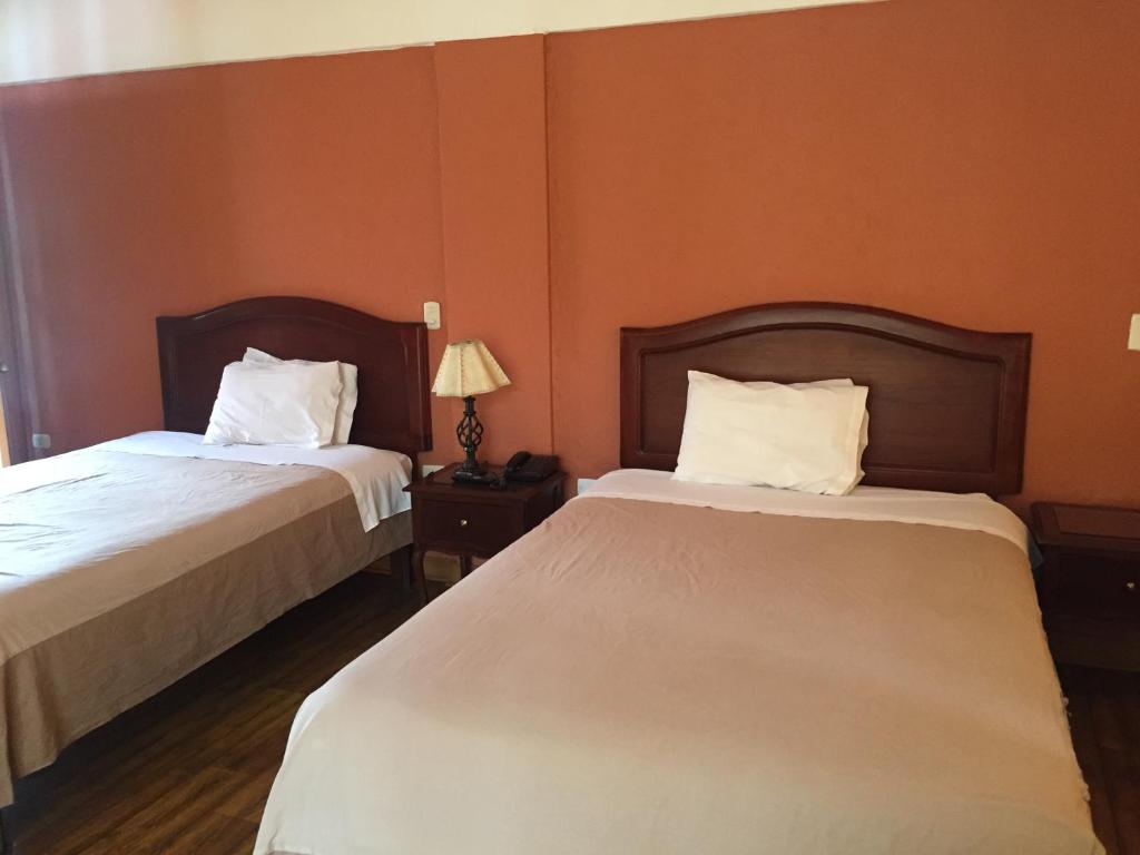 Postel nebo postele na pokoji v ubytování Hotel Pisonay Pueblo