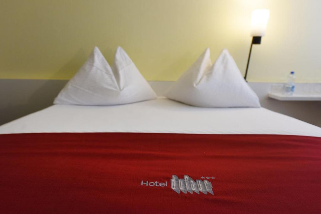 Voodi või voodid majutusasutuse Hotel Dufour toas