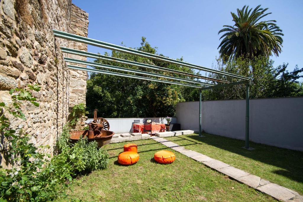 two pumpkins sitting on the grass in a yard at Duplex Pombal in Santiago de Compostela