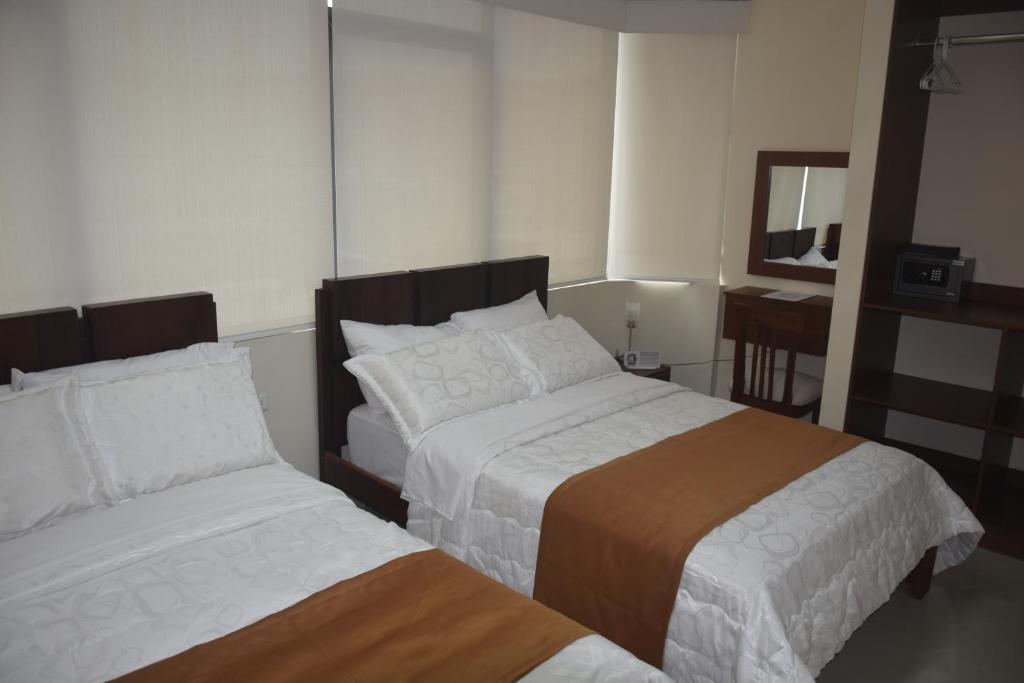 Postel nebo postele na pokoji v ubytování Olan´s Hotel Group