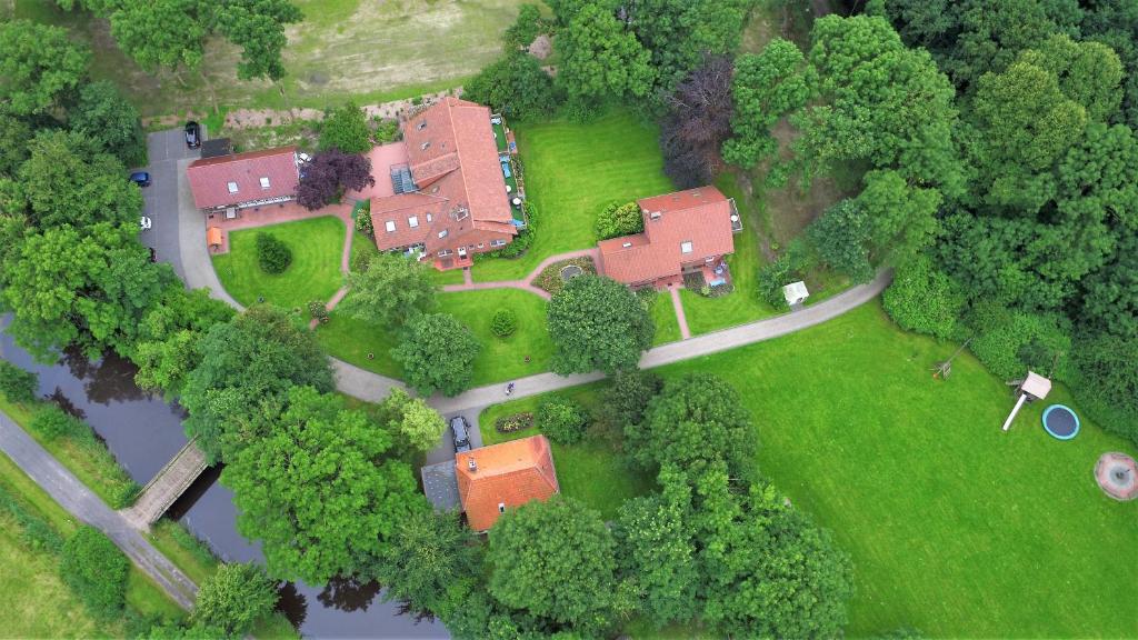 an aerial view of a house in the middle of a forest at Nordsee Urlaubsparadies in Butjadingen