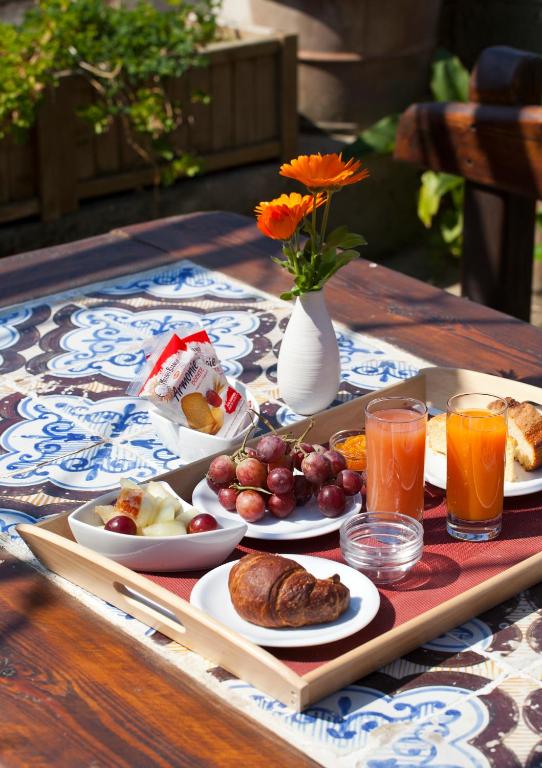 a table topped with plates of food and orange juice at Albergo 'La Vigna' in Procida