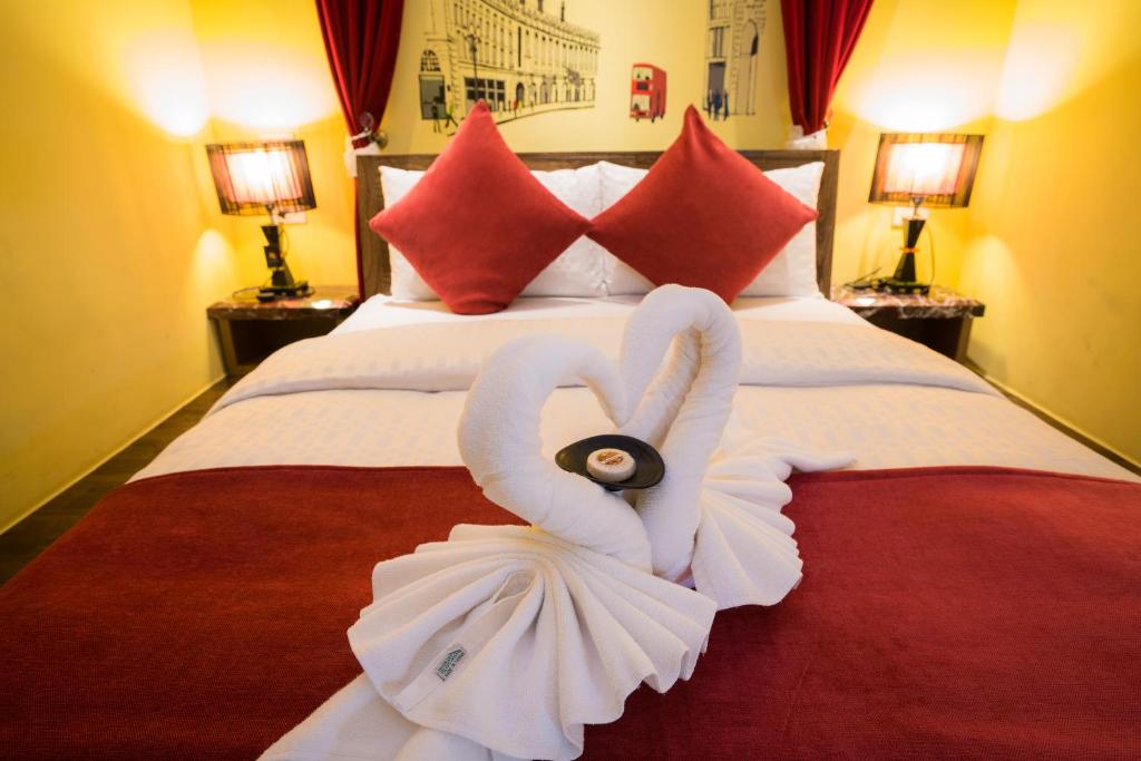 a large white bed with a white pillow on top of it at Kenting 157 Boutique Hotel in Kenting