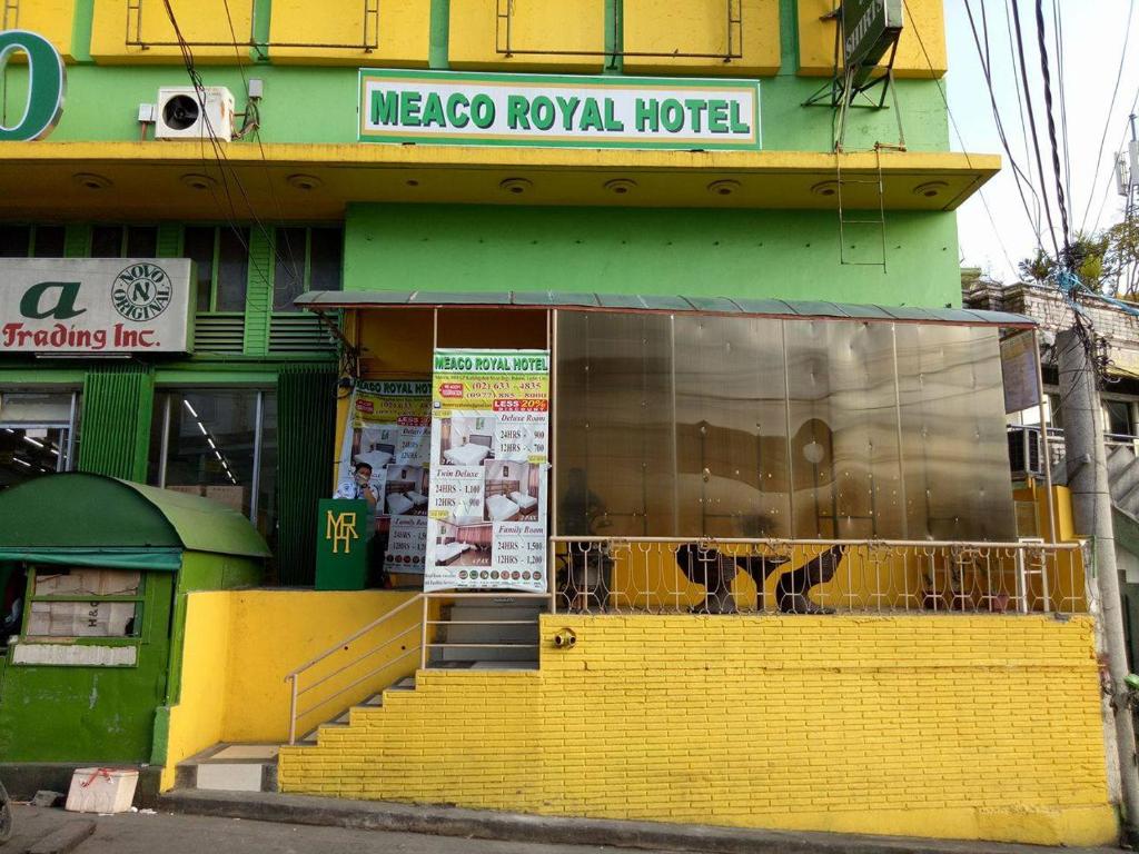 a store front with yellow steps in front of a building at Meaco Royal Hotel - Taytay in Taytay