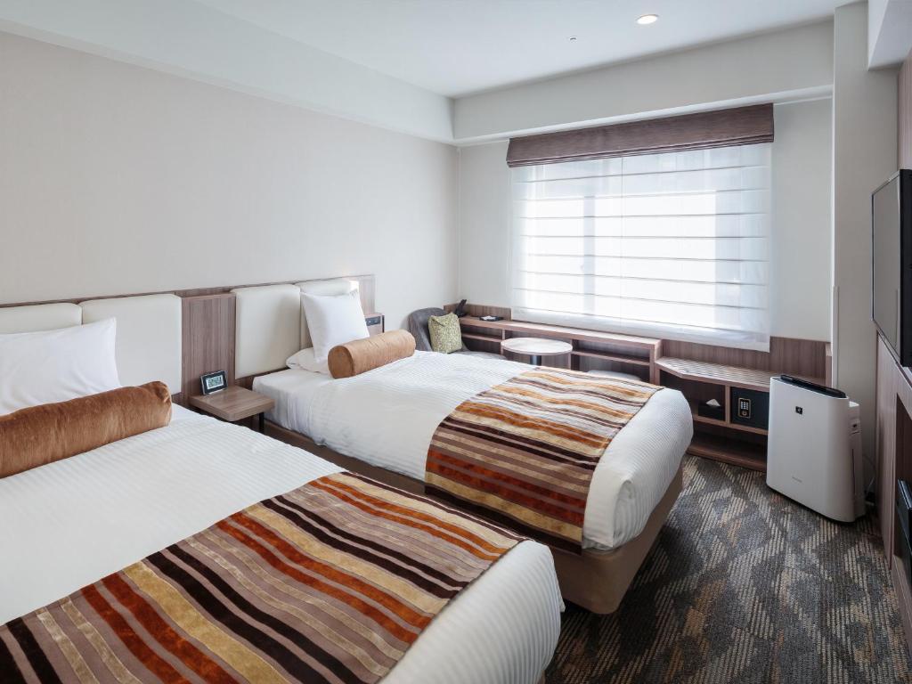 Postel nebo postele na pokoji v ubytování Hotel MYSTAYS PREMIER Dojima