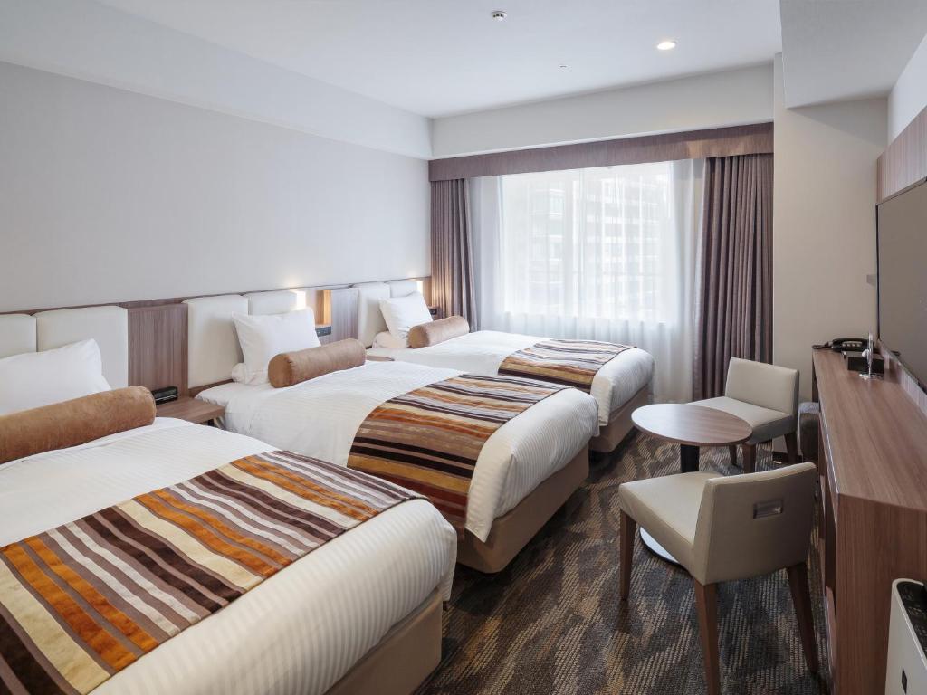 Postel nebo postele na pokoji v ubytování Hotel MYSTAYS PREMIER Dojima