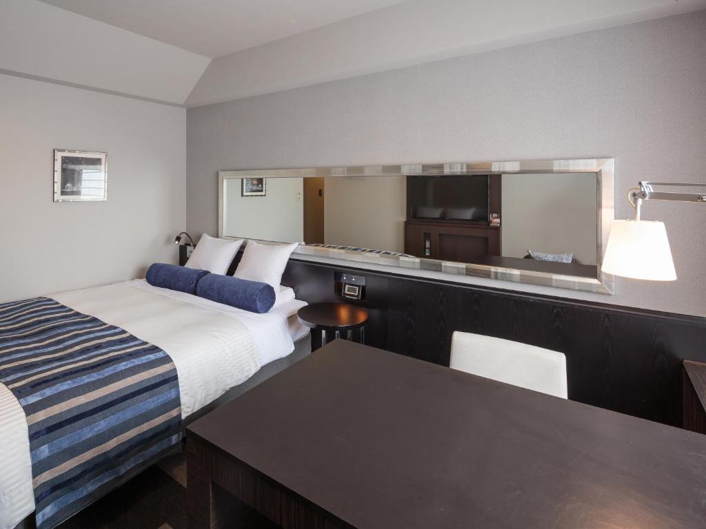 Postel nebo postele na pokoji v ubytování Hotel MYSTAYS PREMIER Dojima