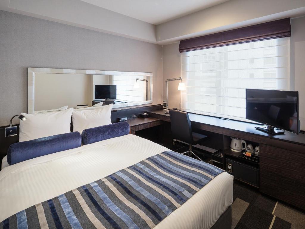 Postel nebo postele na pokoji v ubytování Hotel MYSTAYS PREMIER Dojima