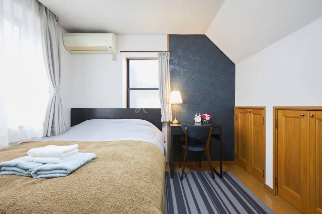 Postel nebo postele na pokoji v ubytování Luxury Guest House in Tokyo Shinjuku