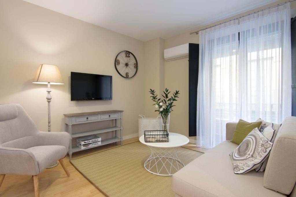 a living room with a couch and a tv at tuGuest Catedral Apartment in Granada