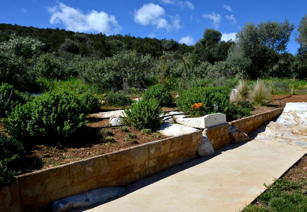 a garden with a retaining wall and plants at Marathon Eco Stay in Marathon