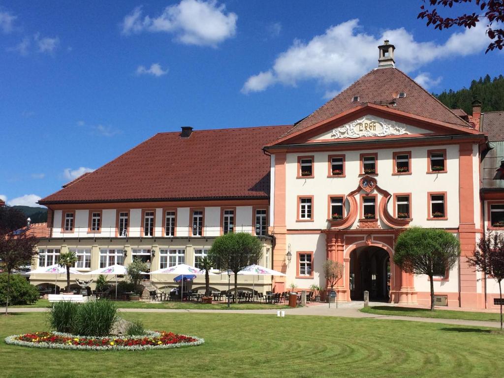 a large white building with a brown roof at Hotel Klosterhof in St. Blasien