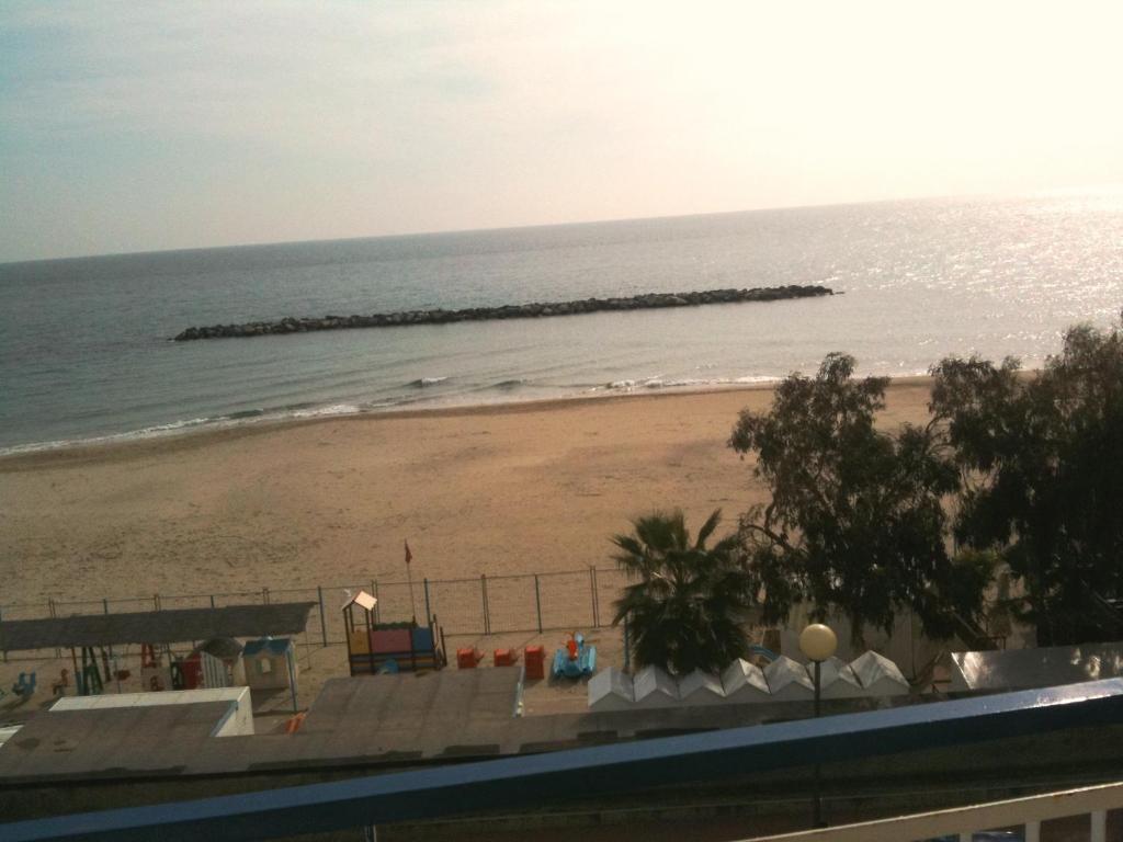 a view of a beach and the ocean at Hotel Svizzera in Arma di Taggia