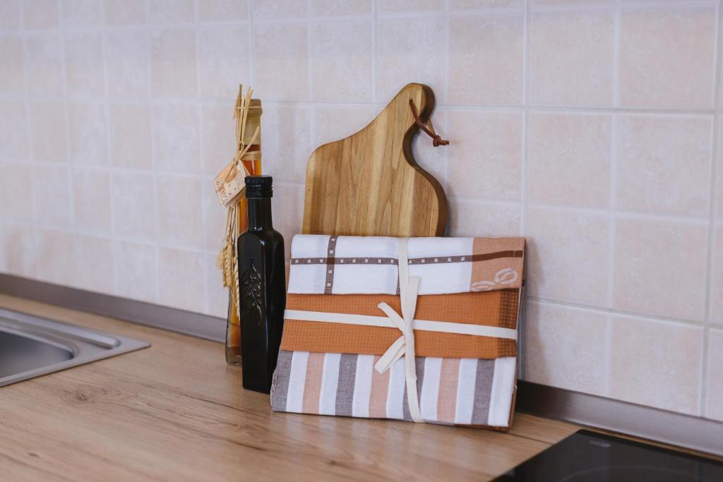 a bottle of wine and a guitar on a kitchen counter at SeaView Apartments in Koper