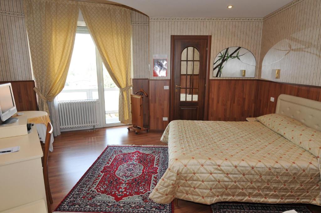 Postel nebo postele na pokoji v ubytování Hotel Fossati
